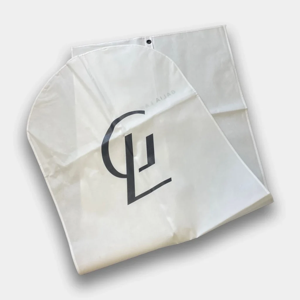 White suit cover with the Galia Lahal logo on the front