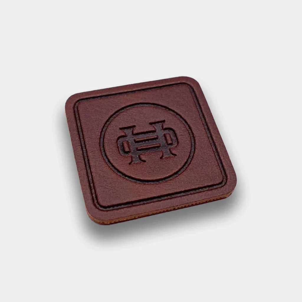 Dark brown leather patch with logo