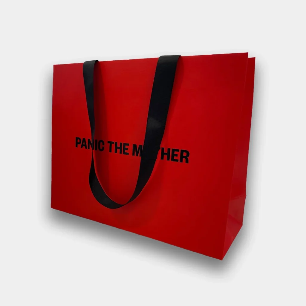 Red paper carrier bag with black handle