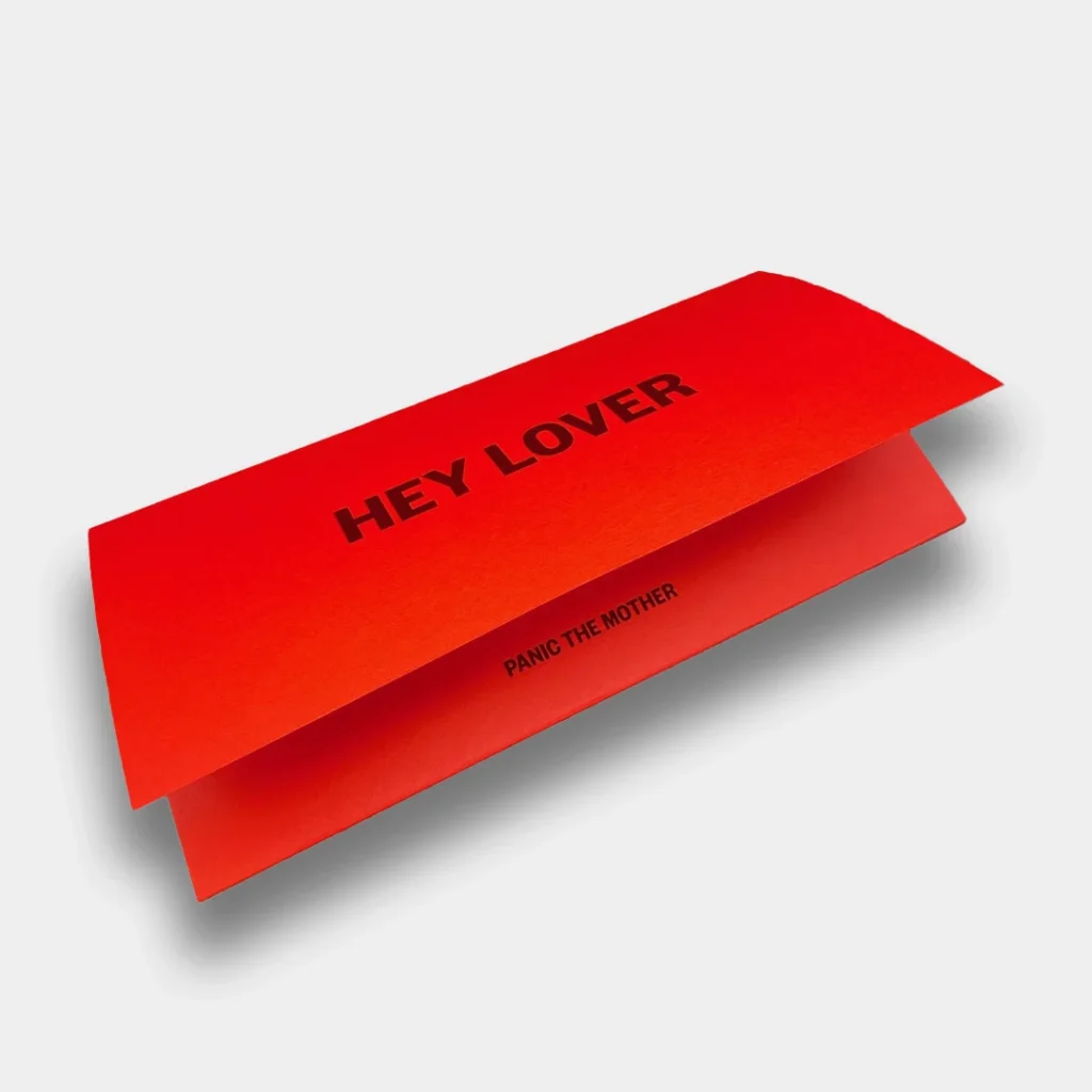 Red packaging accessory with "Hey Lover" text on the front